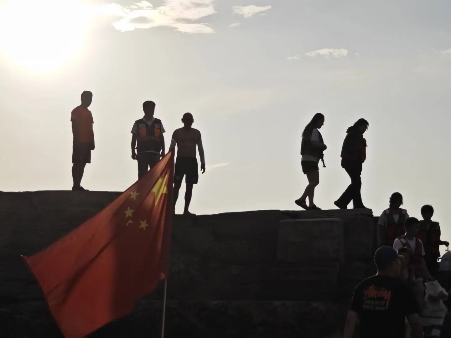 Silhouetted people and volunteers in late afternoon light