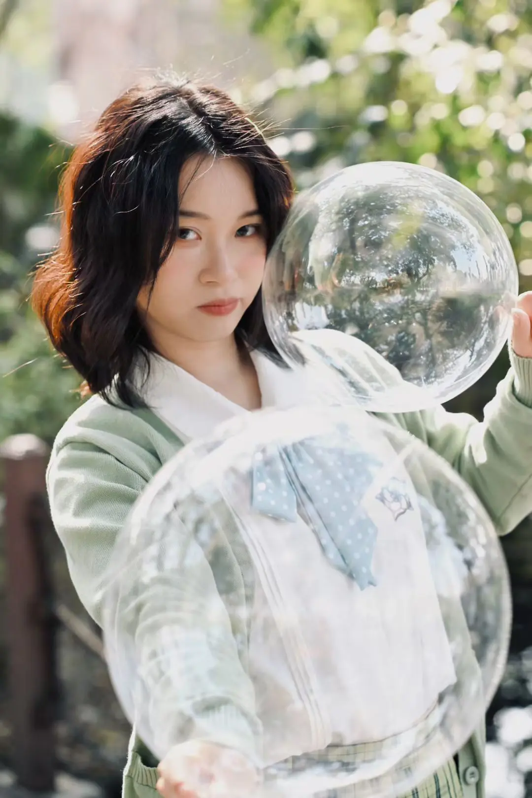 A portrait composed through clear bubbles in sunlight